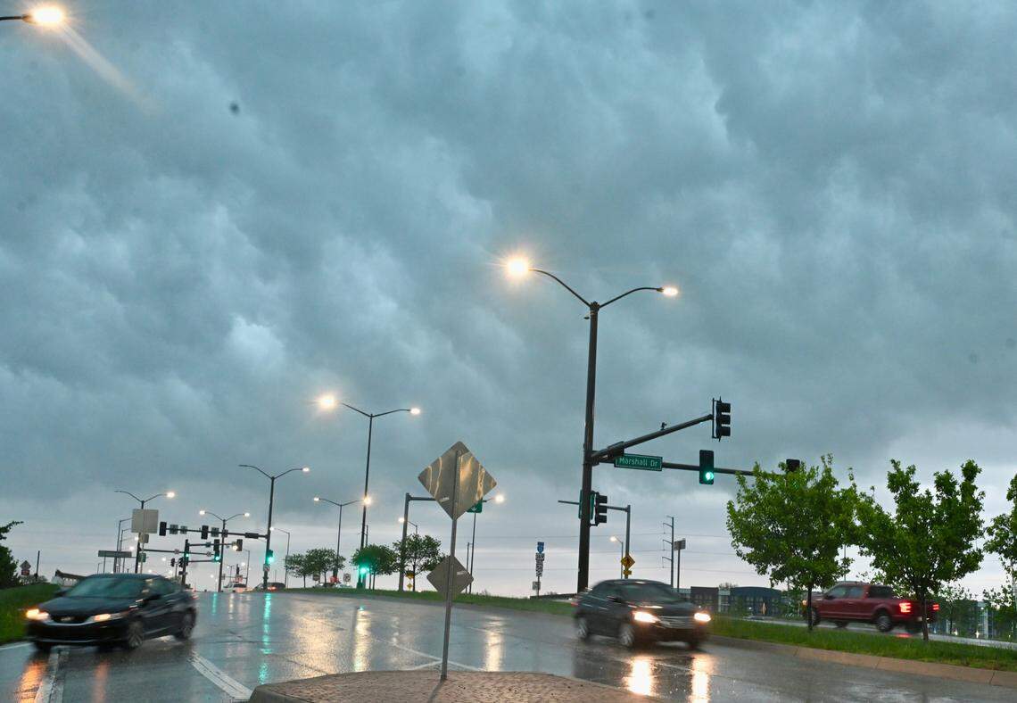 Rain pours down amid severe thunderstorms and a flash flood warning at the intersection of 95th Street and Marshall Drive on Friday, April 17, in Lenexa.