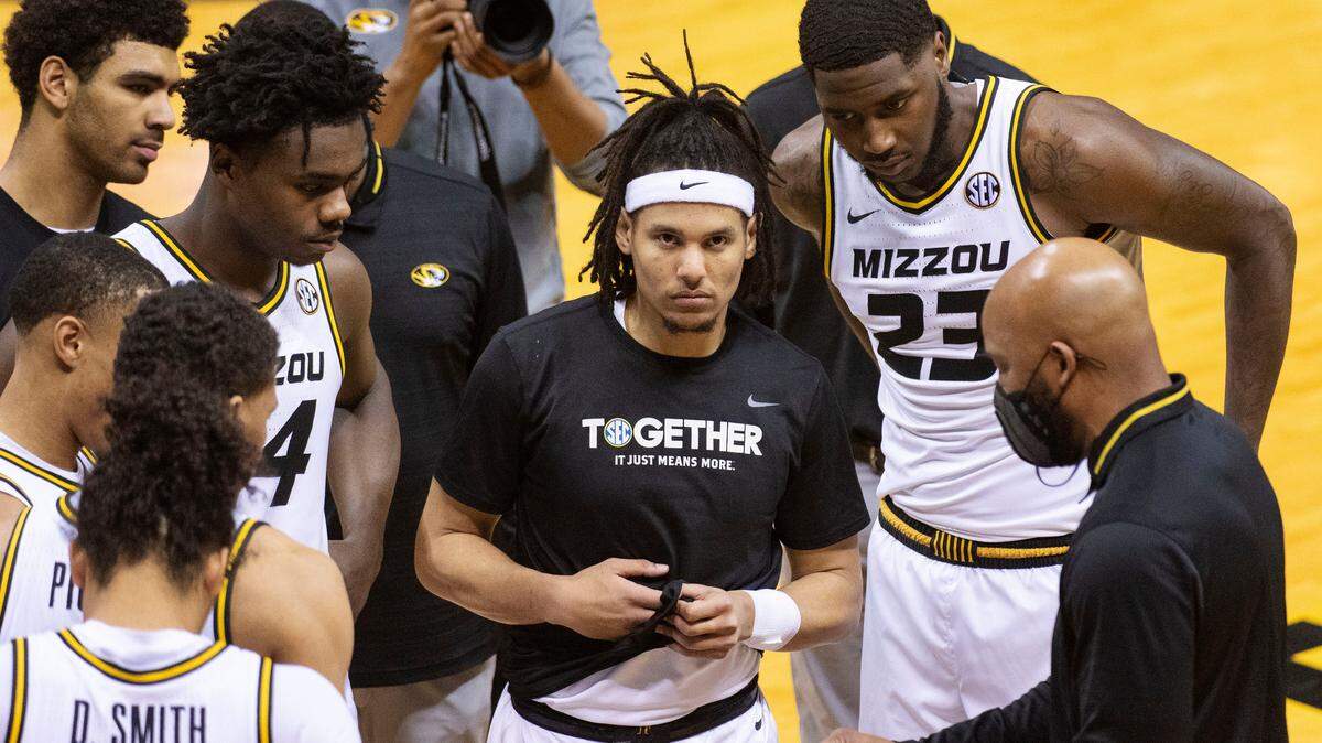 Missouri’s Drew Buggs, center, joins teammates as they listen to head coach Cuonzo Martin, right, before the start of an NCAA college basketball game against TCU Saturday, Jan. 30, 2021, in Columbia, Mo. (AP Photo/L.G. Patterson)
