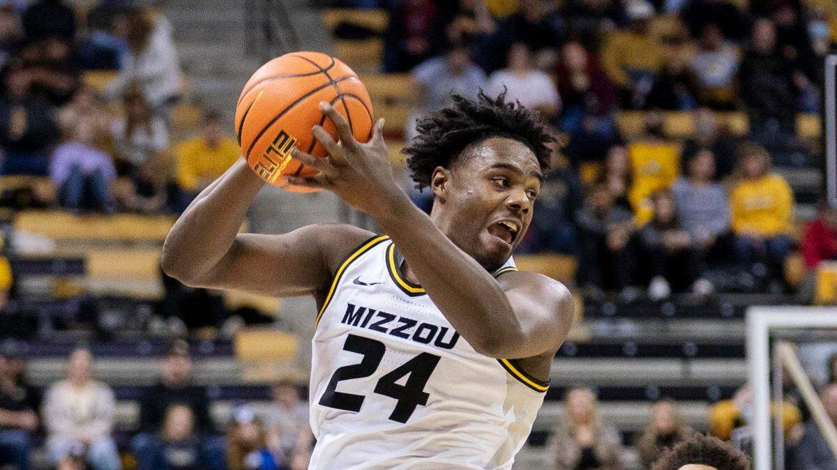 Missouri’s Kobe Brown, left, pulls down a rebound over Alabama’s Darius Miles, right, during the second half of an NCAA college basketball game Saturday, Jan. 8, 2022, in Columbia, Mo. Missouri won 92-86. (AP Photo/L.G. Patterson)