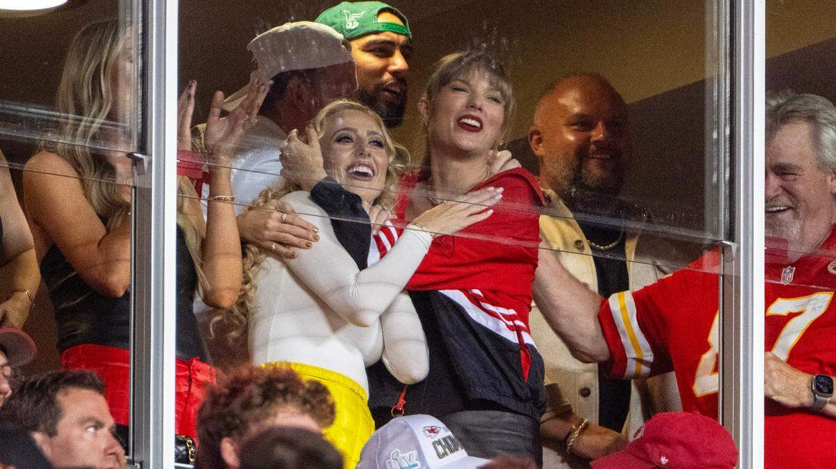 The hug that won the night: Brittany Mahomes, left, and Taylor Swift celebrated after a catch by Chiefs tight end Travis Kelce during the Thursday night game against the Denver Broncos. The images went viral on social media.