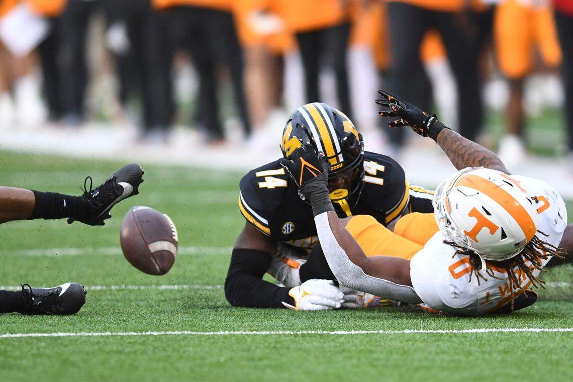 Tennessee Volunteers running back Jaylen Wright fumbles the football on a tackle by Missouri Tigers linebacker Triston Newson (No. 14) on Saturday at Faurot Field.