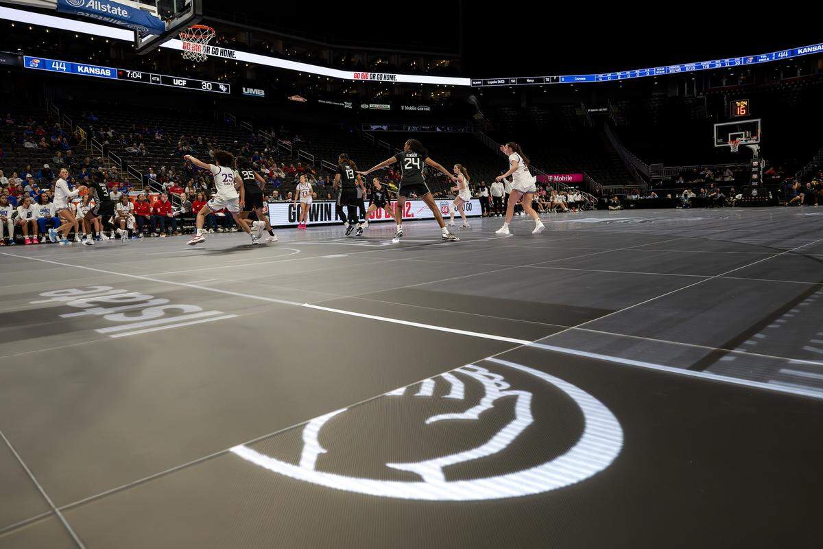 The Kansas Jayhawks and the UCF Knights continue to play in the fourth quarter after LED lights malfunctioned during the Big 12 Women's Basketball Tournament at T-Mobile Center on Wednesday, March 4, 2026, in Kansas City.