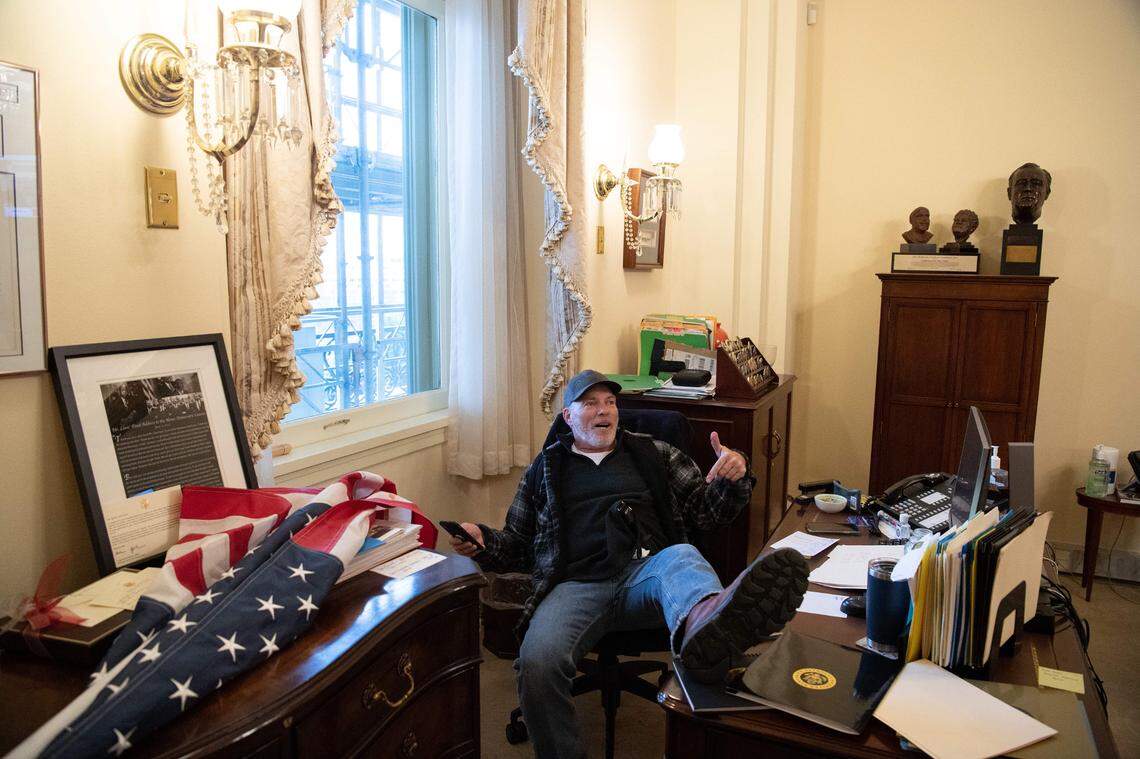 A supporter of U.S. President Donald Trump sits inside the office of U.S. Speaker of the House Nancy Pelosi after he stormed the U.S. Capitol in Washington, D.C., on Wednesday, Jan. 6, 2021. Demonstrators breeched security and entered the Capitol as Congress debated the a 2020 presidential election Electoral Vote Certification.