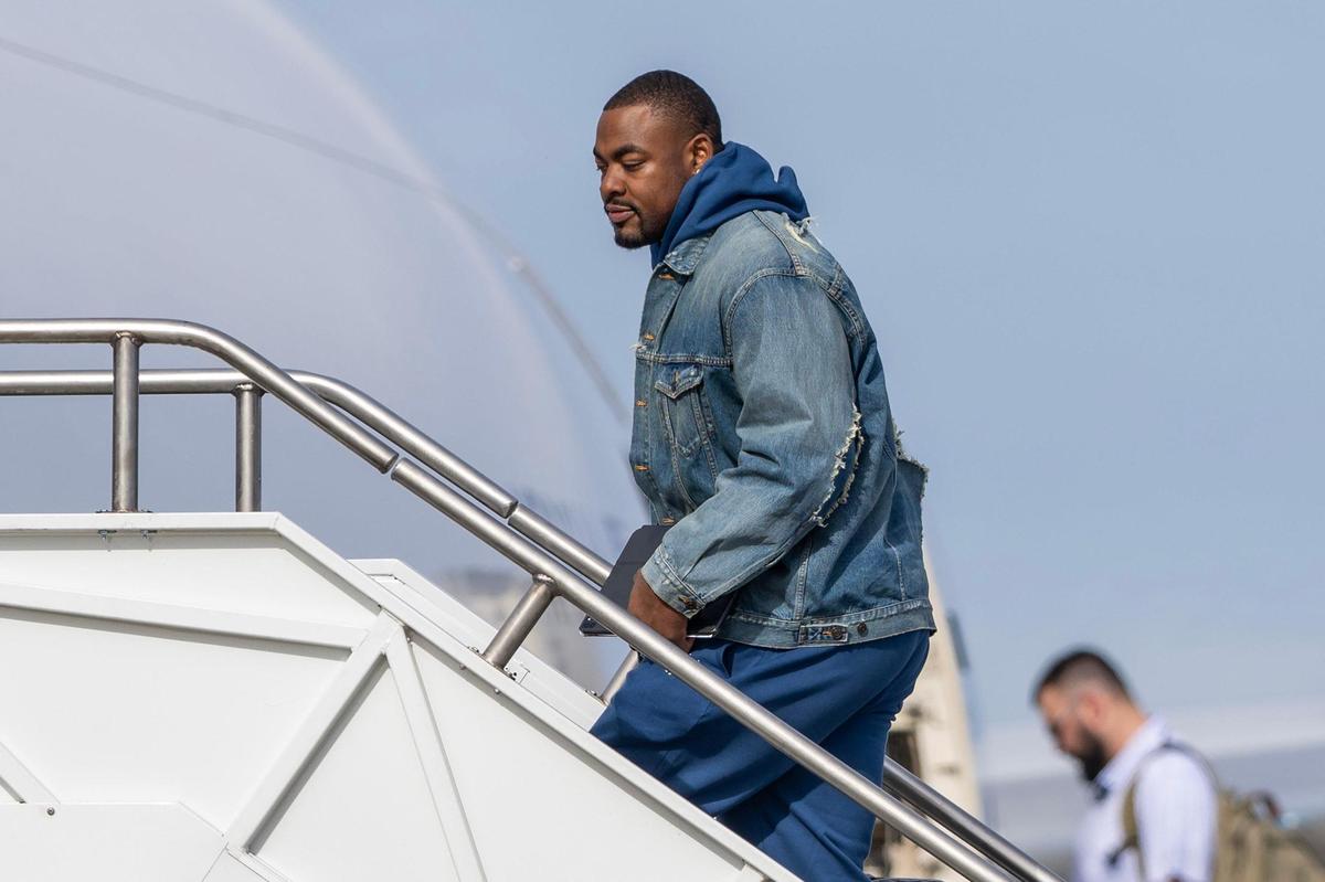 Kansas City Chiefs defensive tackle Chris Jones boards a United Airlines flight with teammates from Kansas City International Airport on Sunday, Feb. 2, 2025, traveling to New Orleans for Super Bowl LIX.