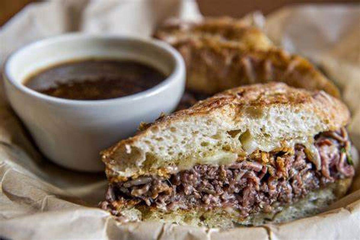 The Dugout Deli’s “Benched” French dip with prime roast beef, Swiss cheese, onion crispy and its Jobu au jus.