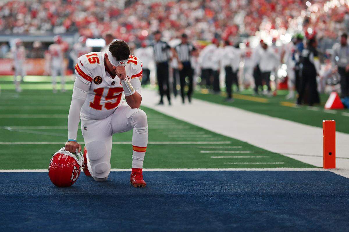 Kansas City Chiefs quarterback Patrick Mahomes kneels in prayer as part of his pre-game ritual ahead of an NFL Week 13 Thanksgiving Day contest against the Dallas Cowboys at AT&T Stadium in Arlington, Texas on Thursday, Nov. 27, 2025.