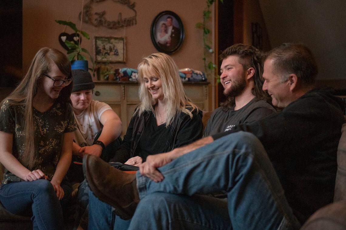 Ashley (left), Robby, Rachelle, R.J. and Rob Appleberry look at family photos at their home in Blue Springs on Wednesday, Jan. 12, 2022. The siblings, from a young age, learned to refer to their brother R.J. using he/him pronouns.