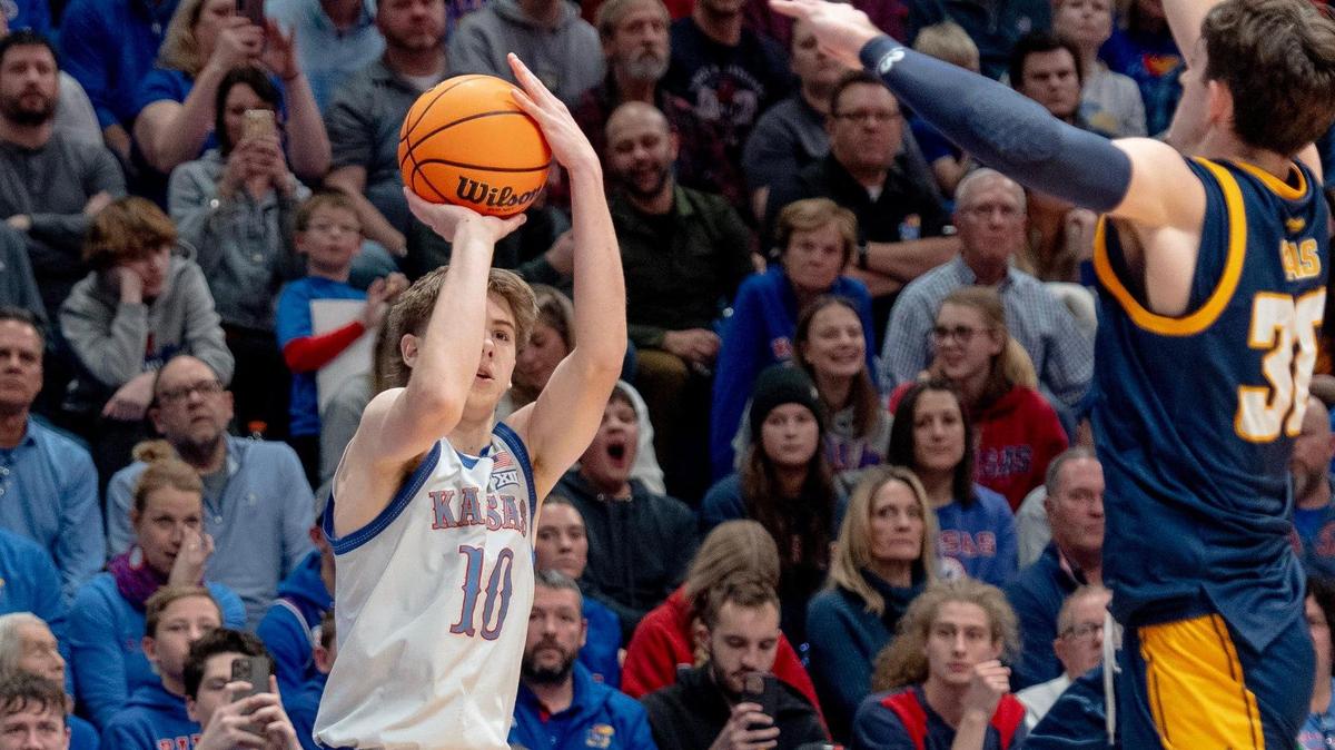 Kansas Jayhawks guard Johnny Furphy shoots a 3-pointer as KC Roos guard Cameron Faas defends during last week’s game in Lawrence.