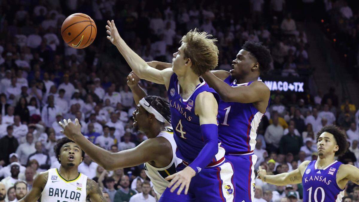 Kansas guard Gradey Dick (4), Kansas guard Joseph Yesufu (1) and Baylor forward Flo Thamba, second from left, reach for the ball during the second half of a game Monday, Jan. 23, 2023, in Waco, Texas.