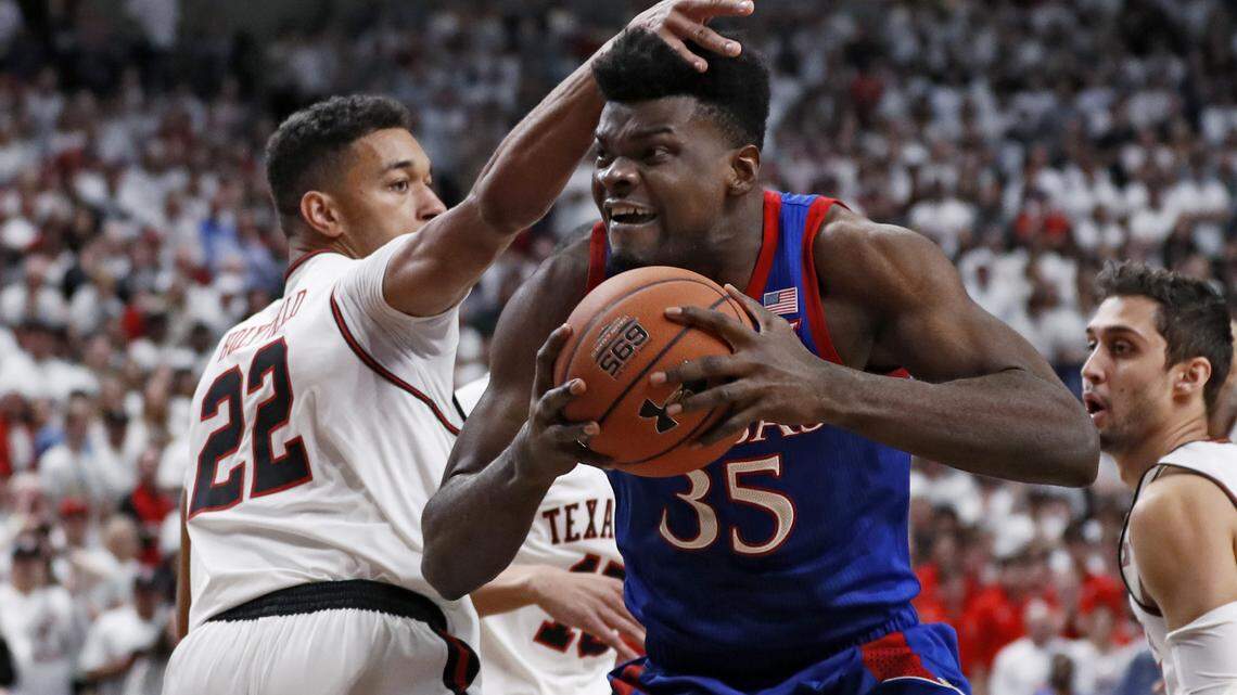 Texas Tech’s TJ Holyfield (22) defends against Kansas’ Udoka Azubuike (35) during the first half of an NCAA college basketball game Saturday, March 7, 2020, in Lubbock, Texas. (AP Photo/Brad Tollefson)