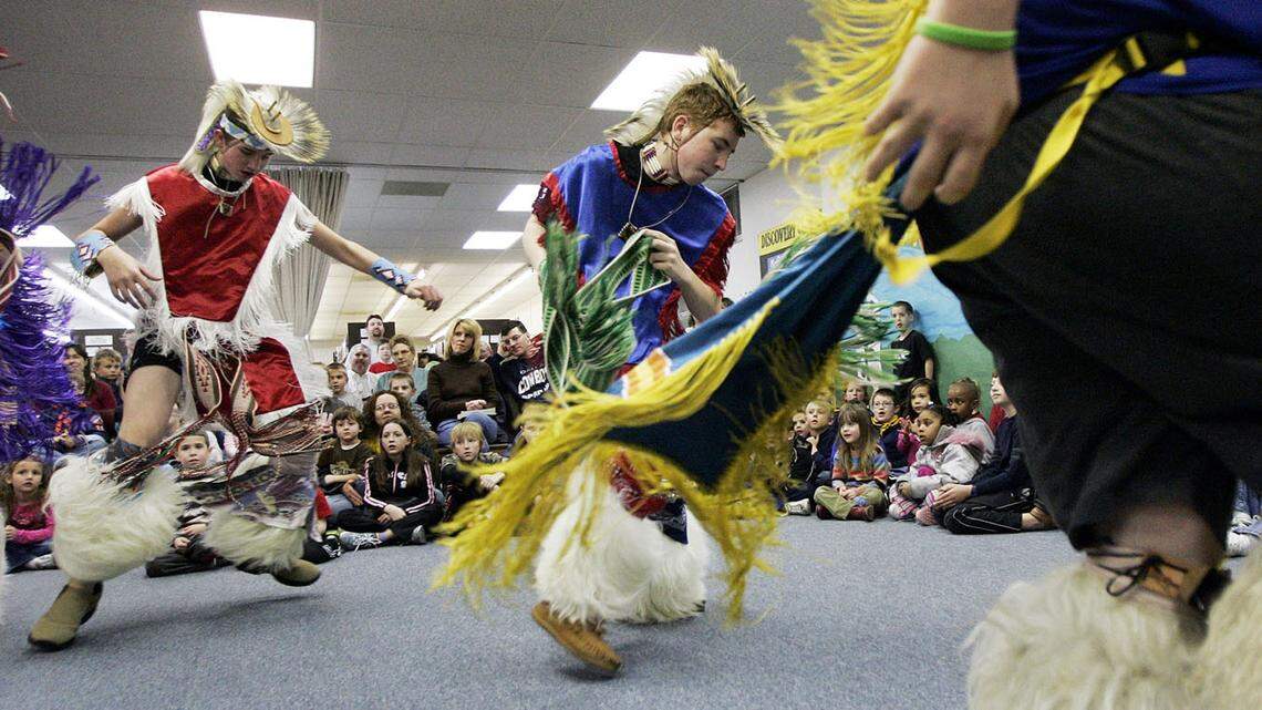 Mic-O-Say dancers, Boy Scouts dressed in Native American dance costumes, participated in a Native American dance demonstration for children at a library program.