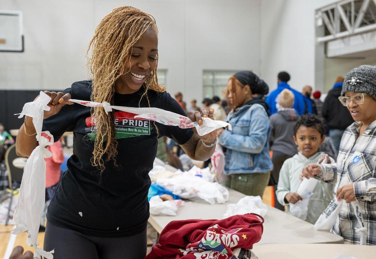 Volunteer Anissa Anthony ties plastic bags together as part of a project to make plarn mats, sleeping mats made from plastic bags that are crocheted together, during the YMCA MLK Day of Service on Monday, Jan. 20, 2025, at the Cleaver Family YMCA in Kansas City. It takes about 600 bags to create a plarn mat, which will be donated to the unhoused or others in need.