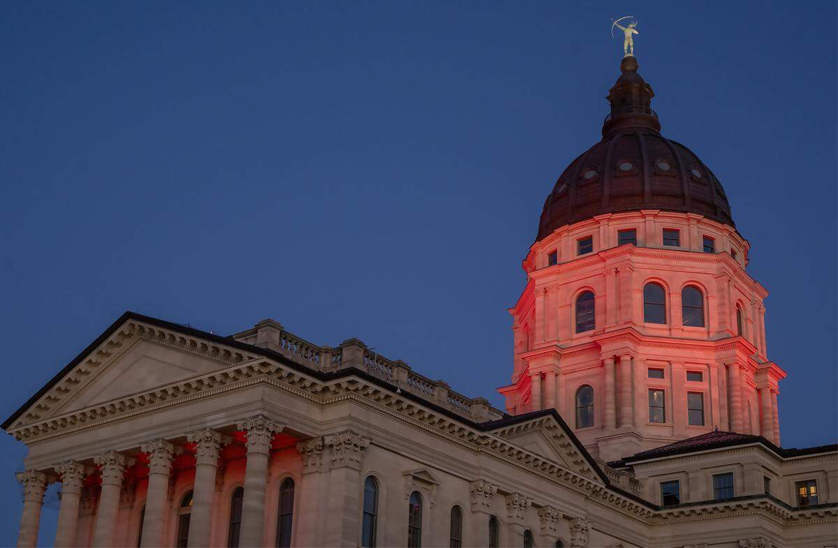The Kansas Statehouse is bathed in red light after Kansas Gov. Laura Kelly announced Monday, Dec. 22, 2025, that the Kansas City Chiefs will build their new stadium in Kansas City, Kansas. The decision marks a major win for the state, bringing one of the region’s most prominent sports teams across the state line.