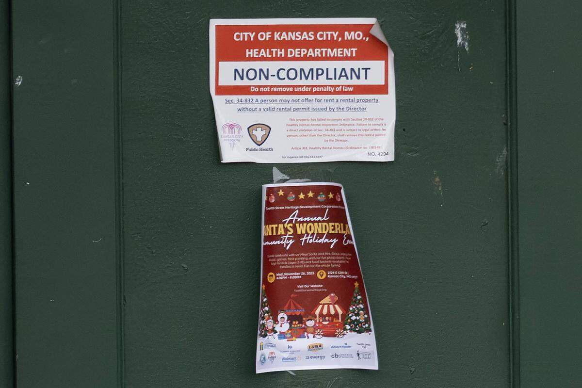 A Kansas City Health Department “non-compliant” notice is posted on the leasing office door at Olive Park Village Apartments on Friday, Nov. 21, 2025, in Kansas City.