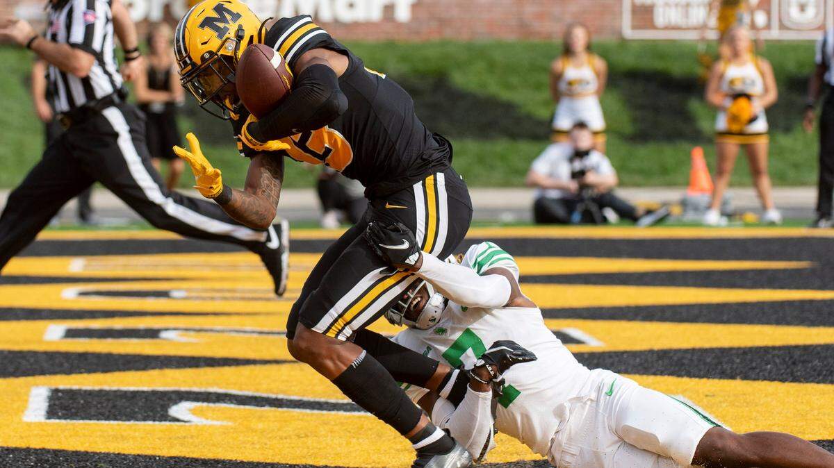 Missouri wide receiver JJ Hester, top, catches a touchdown pass over North Texas defensive back Upton Stout, bottom, during the second quarter of an NCAA college football game Saturday, Oct. 9, 2021, in Columbia, Mo. (AP Photo/L.G. Patterson)