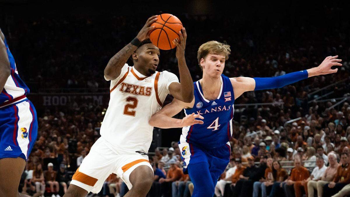 Texas guard Arterio Morris (2) drives toward the hoop as Kansas guard Gradey Dick (4) defends during the second half of a game at the Moody Center in Austin, Saturday, March 4, 2023.