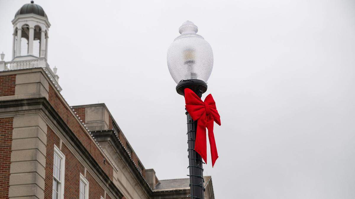 Christmas ribbons have been placed on light poles near the Historic Truman Courthouse, Wednesday, July 3, 2024. The downtown area of Independence, Missouri was being prepared for scenes for a Hallmark Christmas movie that will be filmed there. The movie is based on a story around the Kansas City Chiefs.