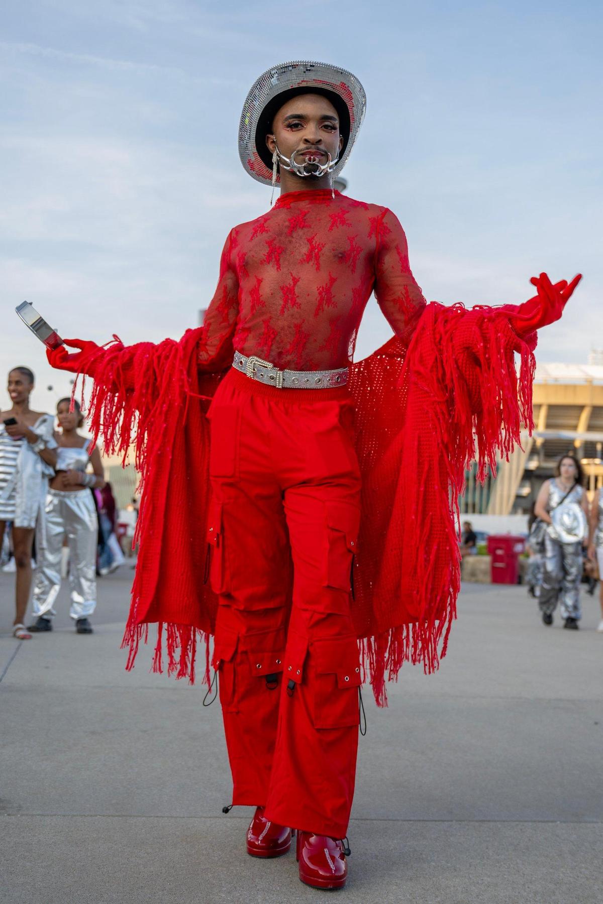 Alex Nyanjom, from Wichita, shows off his all red outfit before attending the last stop of Beyoncé’s Renaissance World Tour at GEHA Field at Arrowhead Stadium on Sunday, Oct. 1, 2023, in Kansas City.