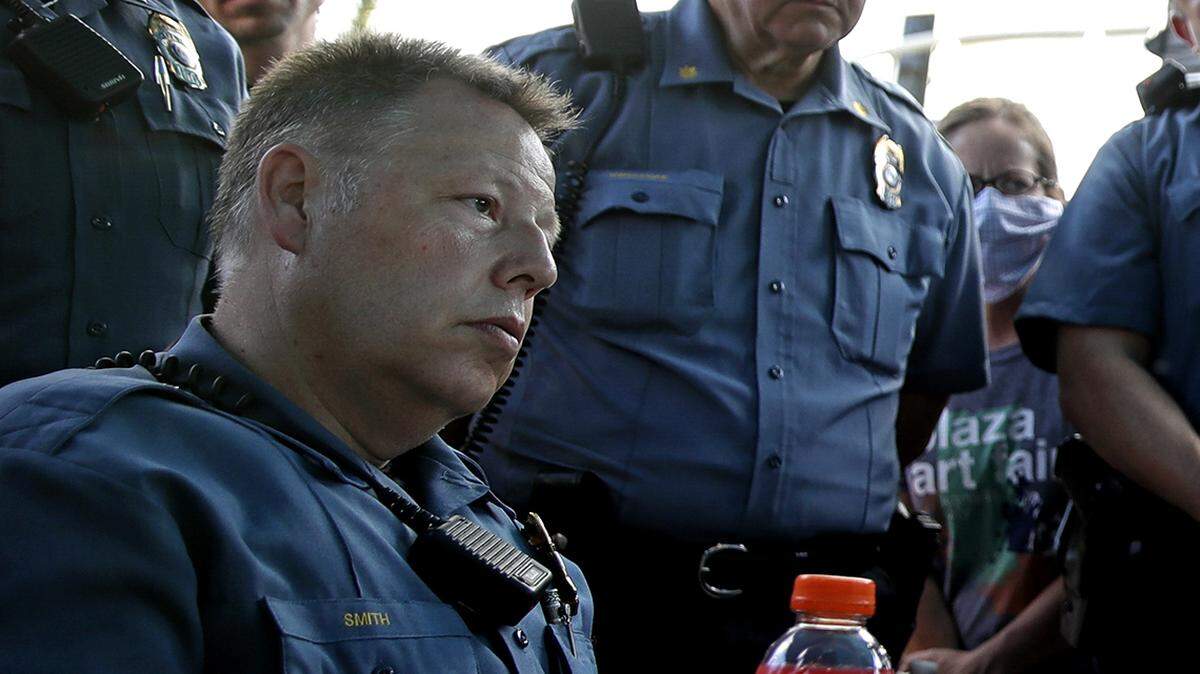 In this June 3, 2020, file photo, Kansas City Police Chief Rick Smith doesn’t wear a mask as he talks with a demonstrator during a unity march to protest against police brutality in Kansas City, Missouri.