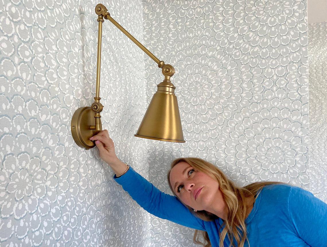 Tamara Day checks out a light fixture in an upstairs room of a Leawood home she is renovating on "Bargain Mansions."
