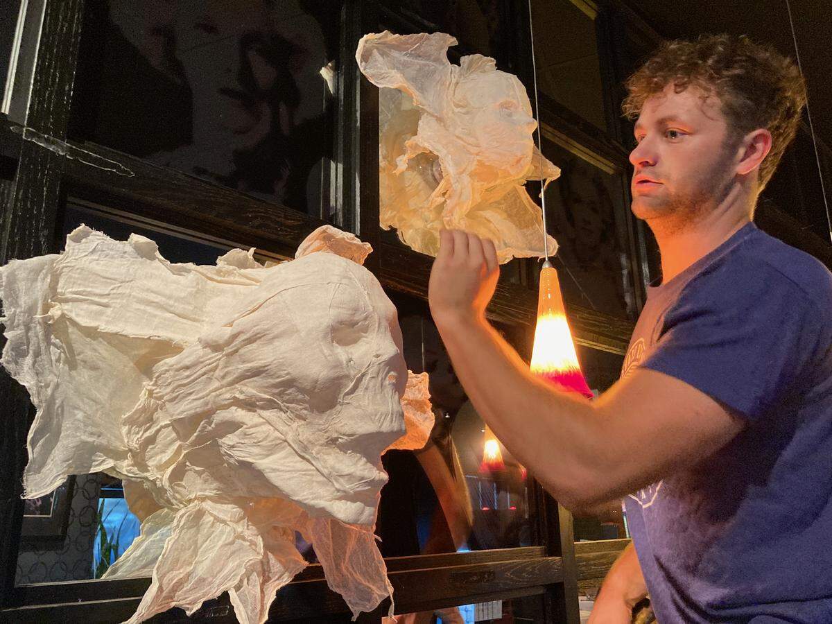 Cafe Trio bartender David Dobbler placed ghoulish and ghostly faces above the bar on decorating day for Halloween in 2023.