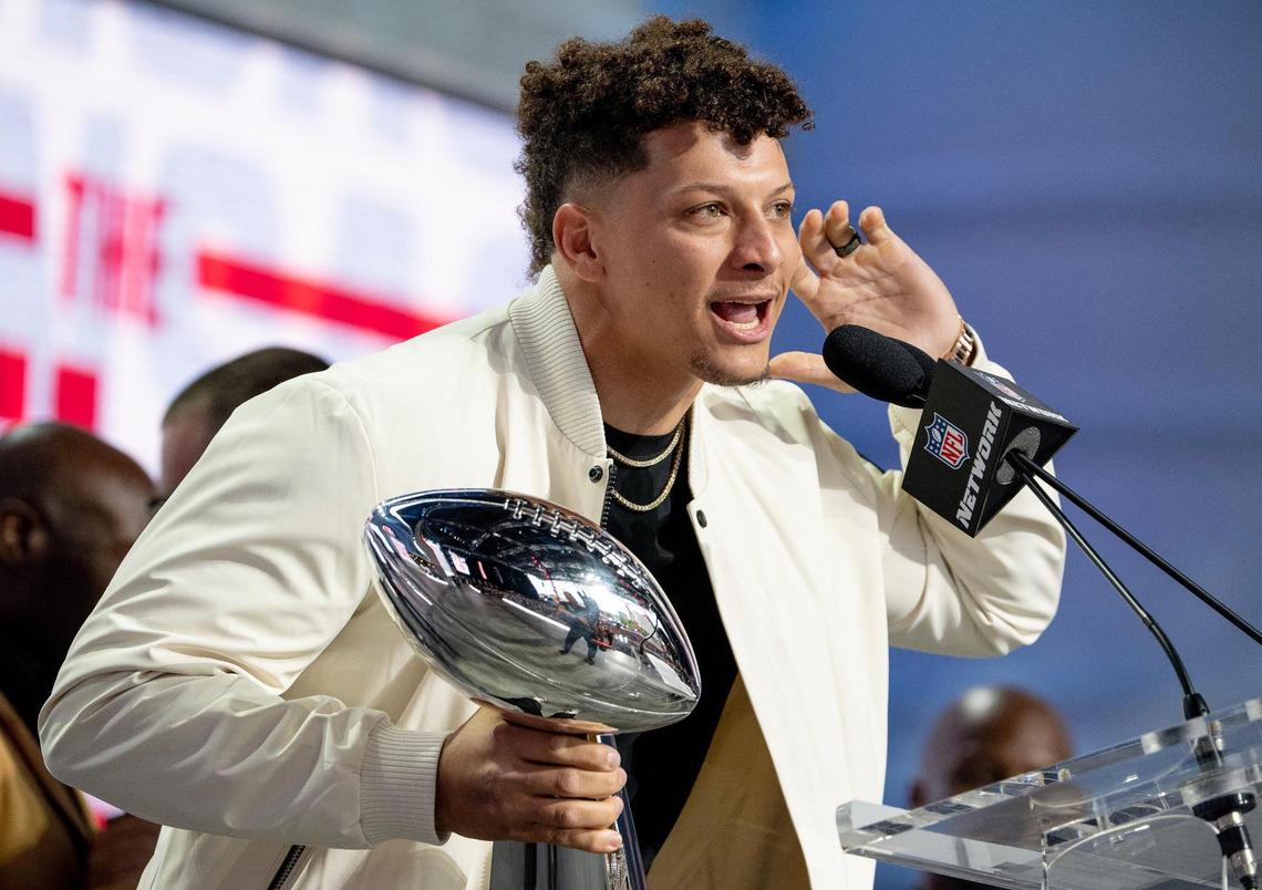 Kansas City Chiefs quarterback Patrick Mahomes eggs on the crowd while holding the Vince Lombardi Super Bowl Trophy during the NFL Draft outside of Union Station on Thursday, April 27, 2023, in Kansas City.