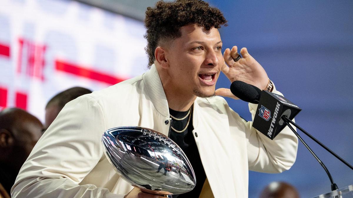 Kansas City Chiefs quarterback Patrick Mahomes eggs on the crowd while holding the Vince Lombardi Super Bowl Trophy during the NFL Draft outside of Union Station on Thursday, April 27, 2023, in Kansas City.