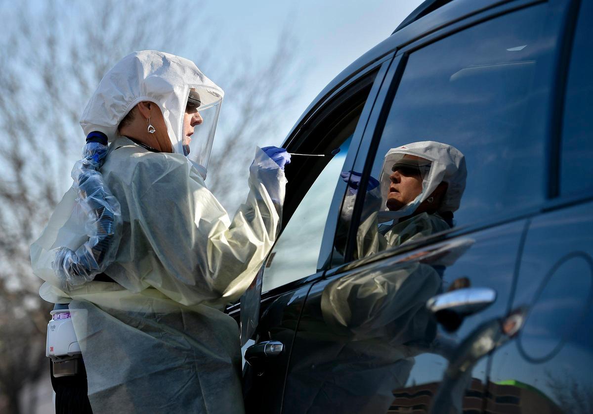 At Truman Medical Center’s drive-up test site, Marcia Waters, a registered nurse, administered COVID-19 tests to approved employees, patients and others. Waters is protected by a PAPR, or powered air purifying respirator, which provides airflow through a filter to her hood.