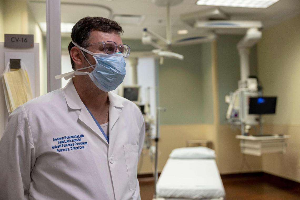 Dr. Andrew Schlachter, pulmonologist and critical care specialist, stands in front of a COVID ICU room at Saint Luke’s Hospital of Kansas City. The hospital is seeing the biggest surges of COVID patients since the pandemic began.
