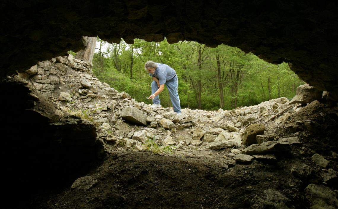 Steve Collins examined a piece of glass at the old Quindaro brewhouse on April 21, 2005, in Kansas City, Kan. The brewhouse will be cleared of debris and foundation stones will be re-layed during upcoming restoration work. Collins is framed by the opening leading into the structure’s barrow-shaped storeroom.