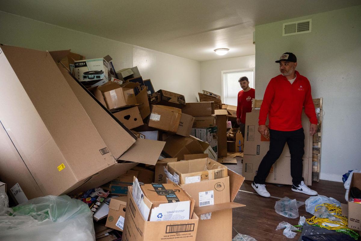 Volunteers walk through one of several areas where residents could claim packing boxes at Aspen Place Apartments in Gardner on Wednesday, May 7, 2025. Residents of the apartment complex were forced from their homes after the city condemned the property due to several safety concerns.