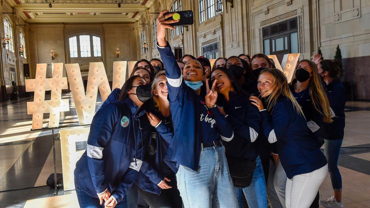 Kansas City’s National Women’s Soccer League team takes a group photo near the lighted sign set up for their welcome home event at Union Station Monday, March 8, 2021. The team returned home after two weeks of training camp in Orlando.