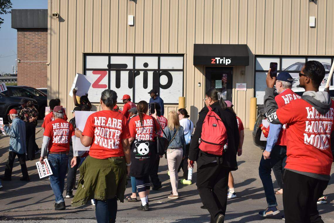 Demonstrators march past taxi operator zTrip’s Kansas City headquarters on Thursday, Oct 10. The company runs the city’s microtransit program, IRIS, which critics say imposes heavy fees and strict policies on drivers.