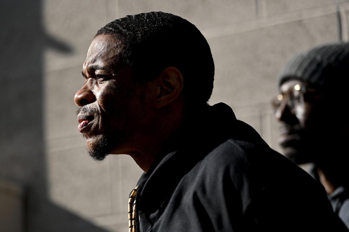 Keith Carnes, left, was freed from prison Monday, April 11, 2022, after 18 years in prison. The prosecutor’s office declined to file charges after the Missouri Supreme Court threw out his conviction for murder and armed criminal action. Carnes and Lamonte McIntyre of Miracle of Innocence listen to speakers.