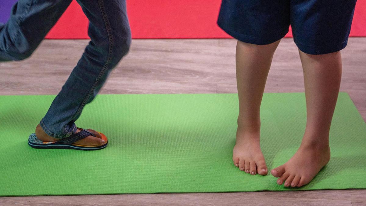 Residents and guests do yoga during summer camp at Newhouse on Tuesday, June 20, 2023, in Kansas City.