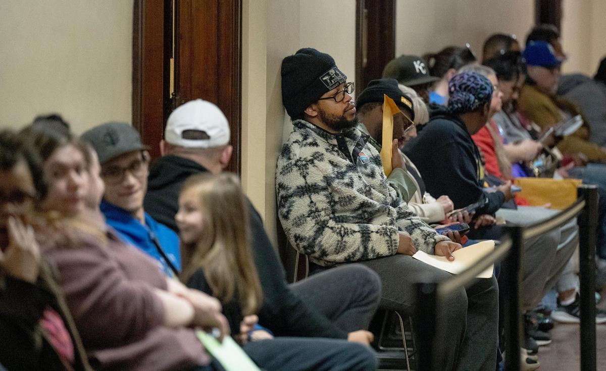 People wait in line to work with staff at the Jackson County Assessment office on Friday, March 29, 2024, in Independence, Missouri.