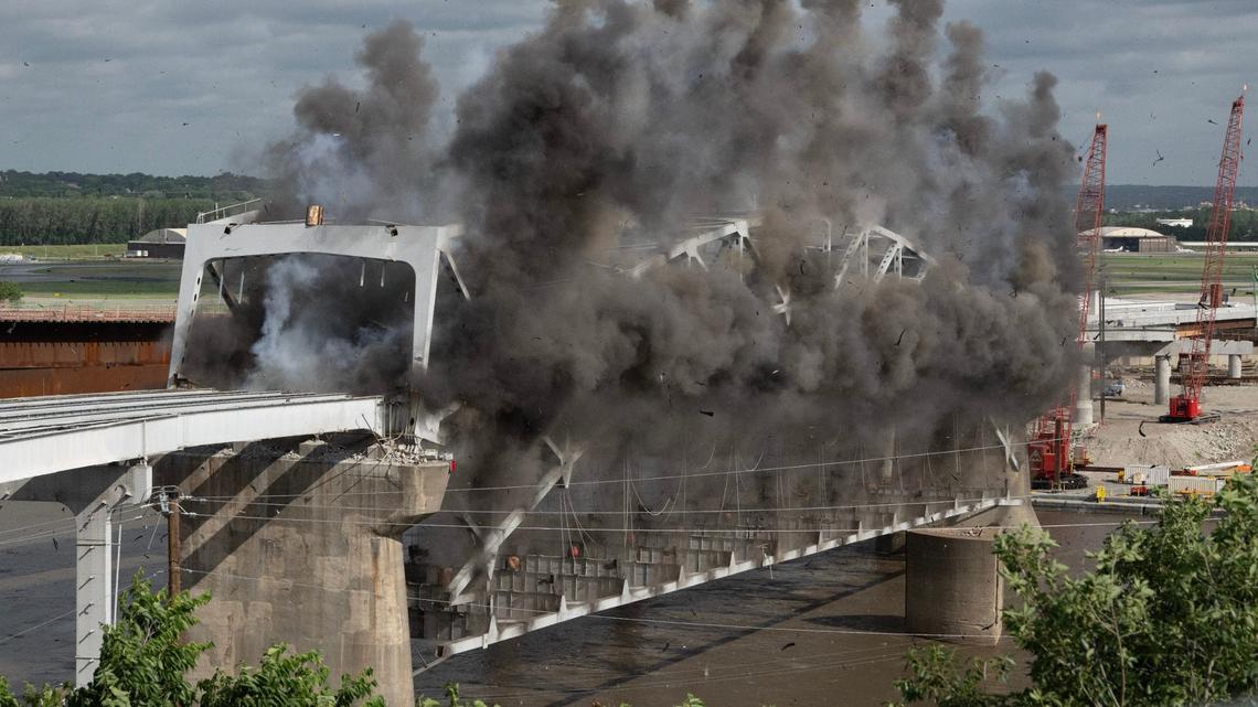 Explosive charges are detonated to take down the final arch of the Buck O’Neil Bridge Tuesday over the Missouri River near downtown Kansas City.