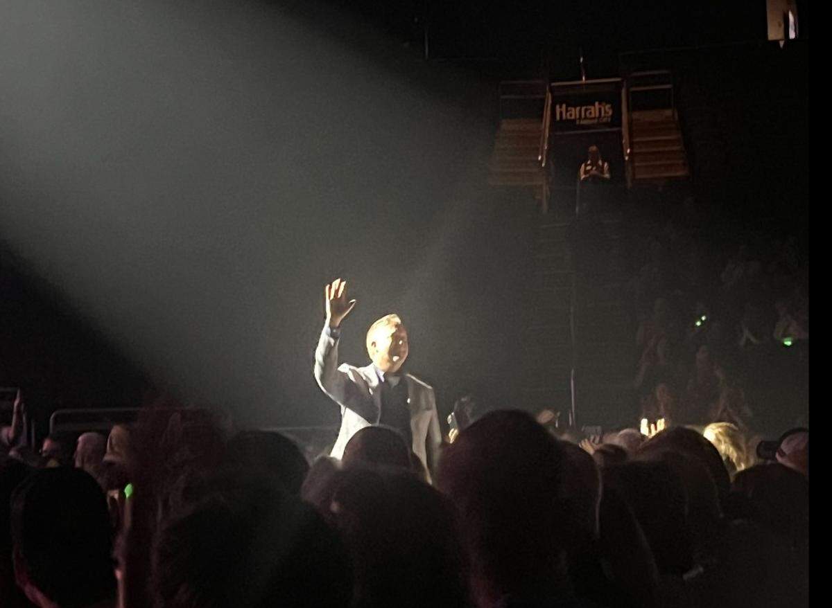 Jeff Smikahl, a music teacher with Olathe Public Schools, waves to the crowd at Barry Manilow’s final show in Kansas City after it was announced that he won $10,000 from the singer’s Manilow Music Project.