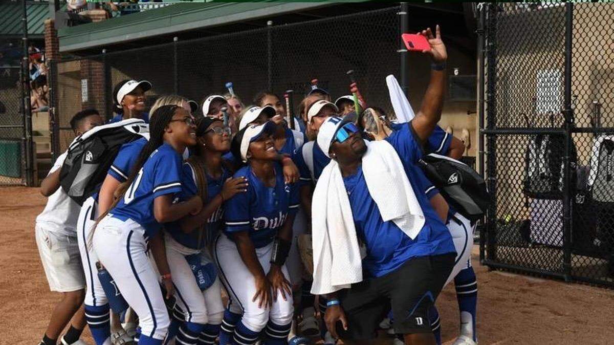 Coach James Lamar takes a selfie with his Lady Dukes players