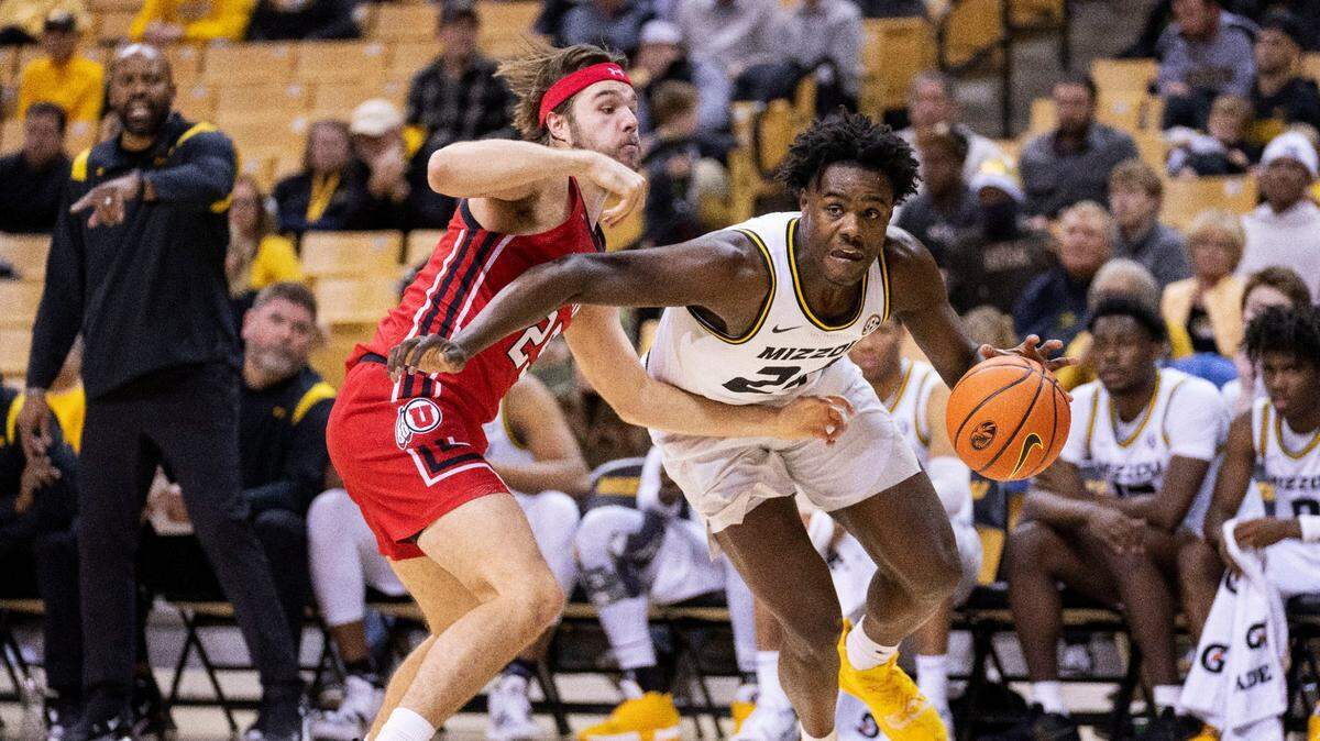 Missouri’s Kobe Brown, right, drives past Utah’s Rollie Worster, left, during the second half of an NCAA college basketball game Saturday, Dec. 18, 2021, in Columbia, Mo. (AP Photo/L.G. Patterson)