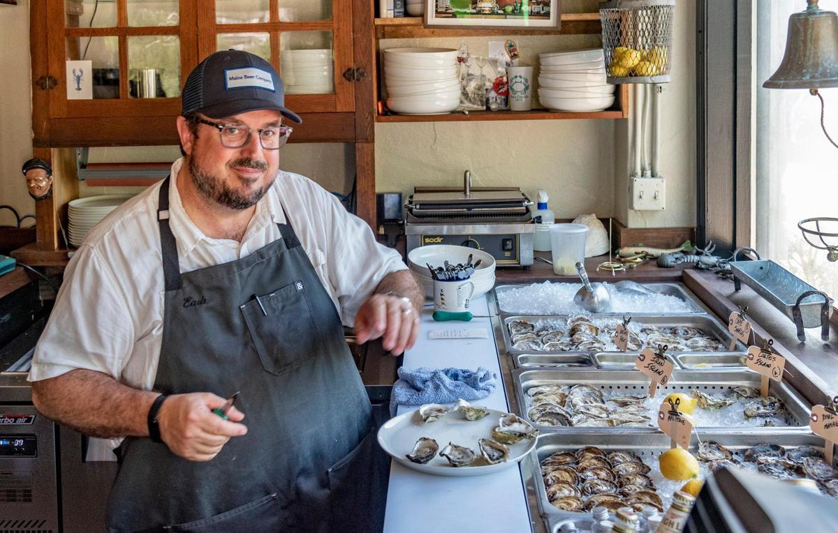 Co-owner Cory Dannehl prepares oysters at Earl’s Premier.