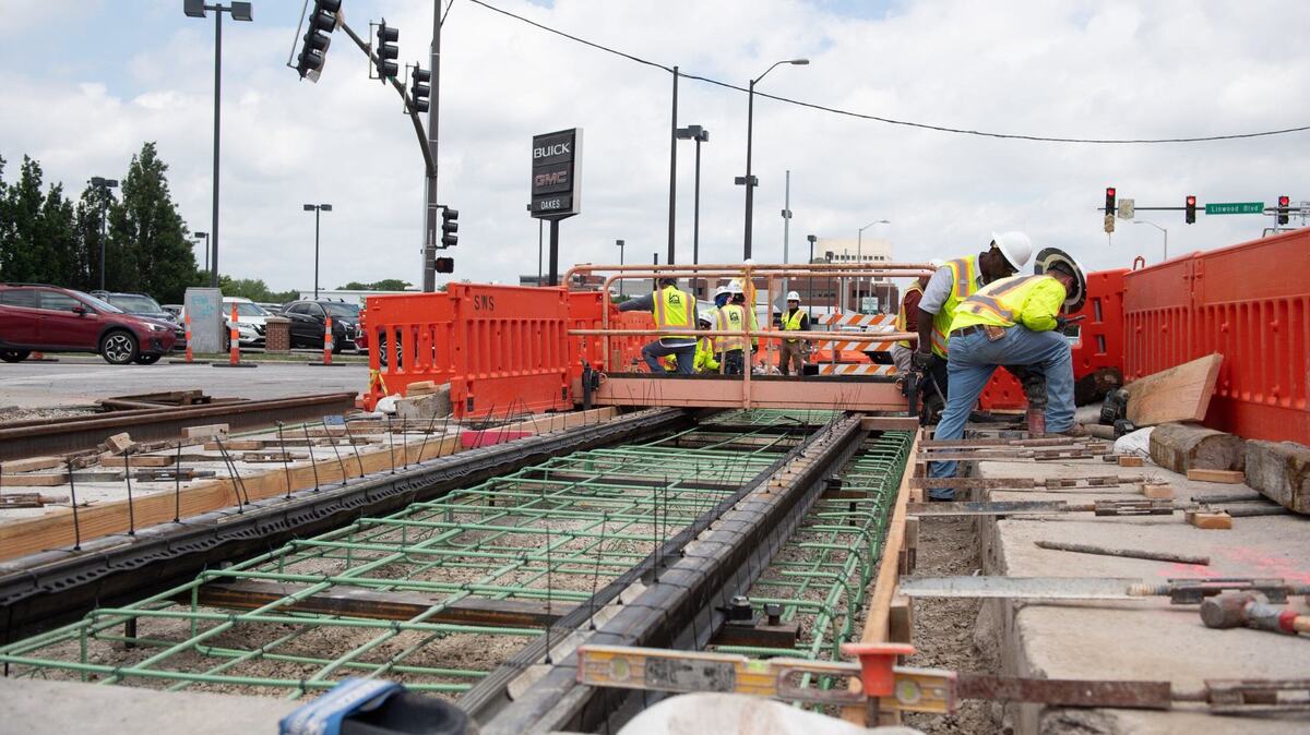 Construction crews work on the KC Streetcar route on Tuesday at the intersection of Main Street and Linwood Boulevard.