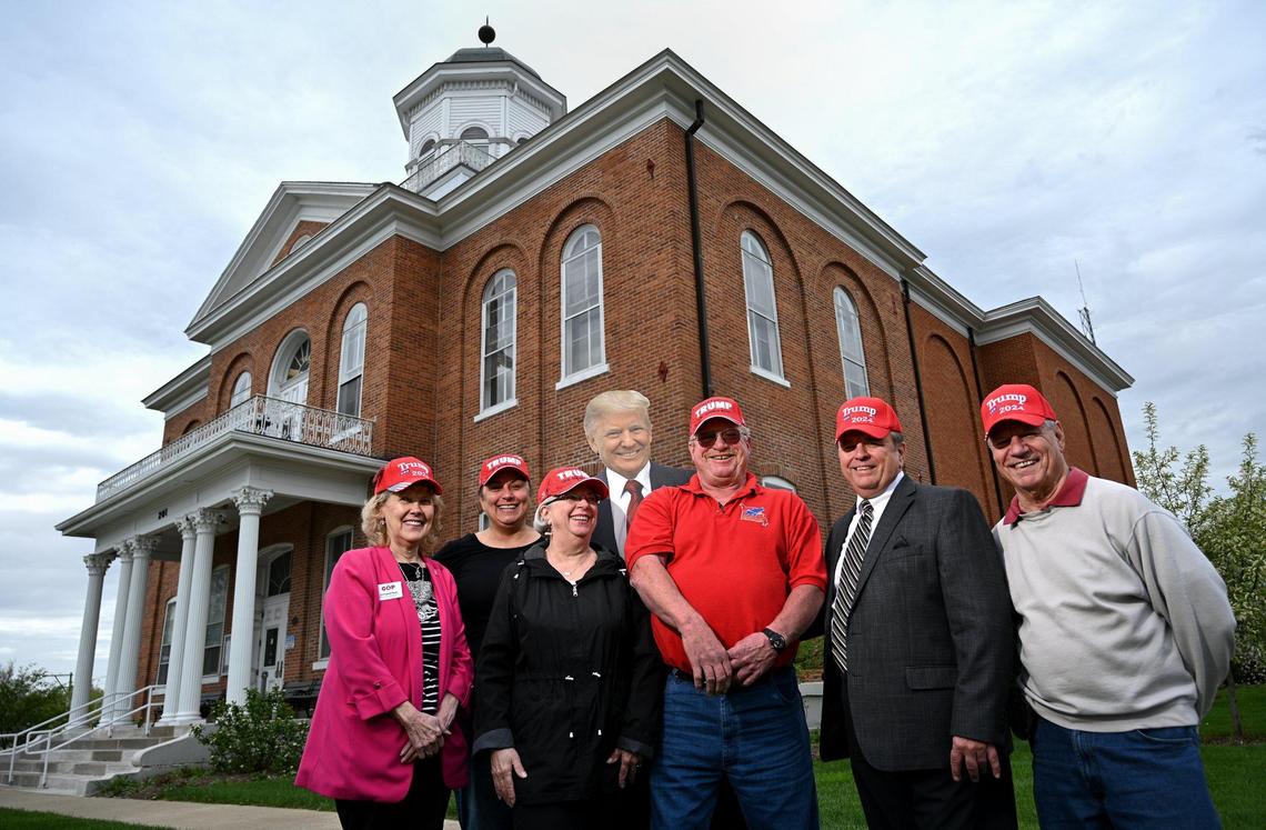 In front of the Lincoln County Courthouse in Troy, Missouri, members of the Lincoln County Republican Club — from left, Carol Boyer, Jessica Zumwalt, Libby Grunick, John Cooper, Gary Grunick and Jerry Boyer — are all in for Donald Trump in 2024. Lincoln County, a rural county northwest of St. Louis, voted 75% for Trump in 2020.