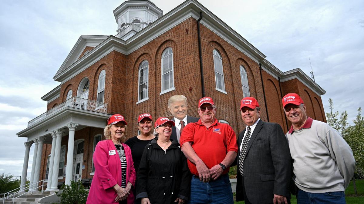 Missouri, members of the Lincoln County Republican Club pose with a cutout of the president in 2022. Lincoln County, a rural county northwest of St. Louis, voted 75% for Donald Trump in 2020 and 77% for him in 2024.