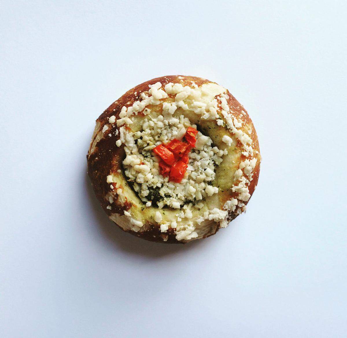 Mud Pie’s pesto stuffed pretzel is filled with arugula pesto, vegan mozzarella cheese, tomatoes and topped with sea salt.