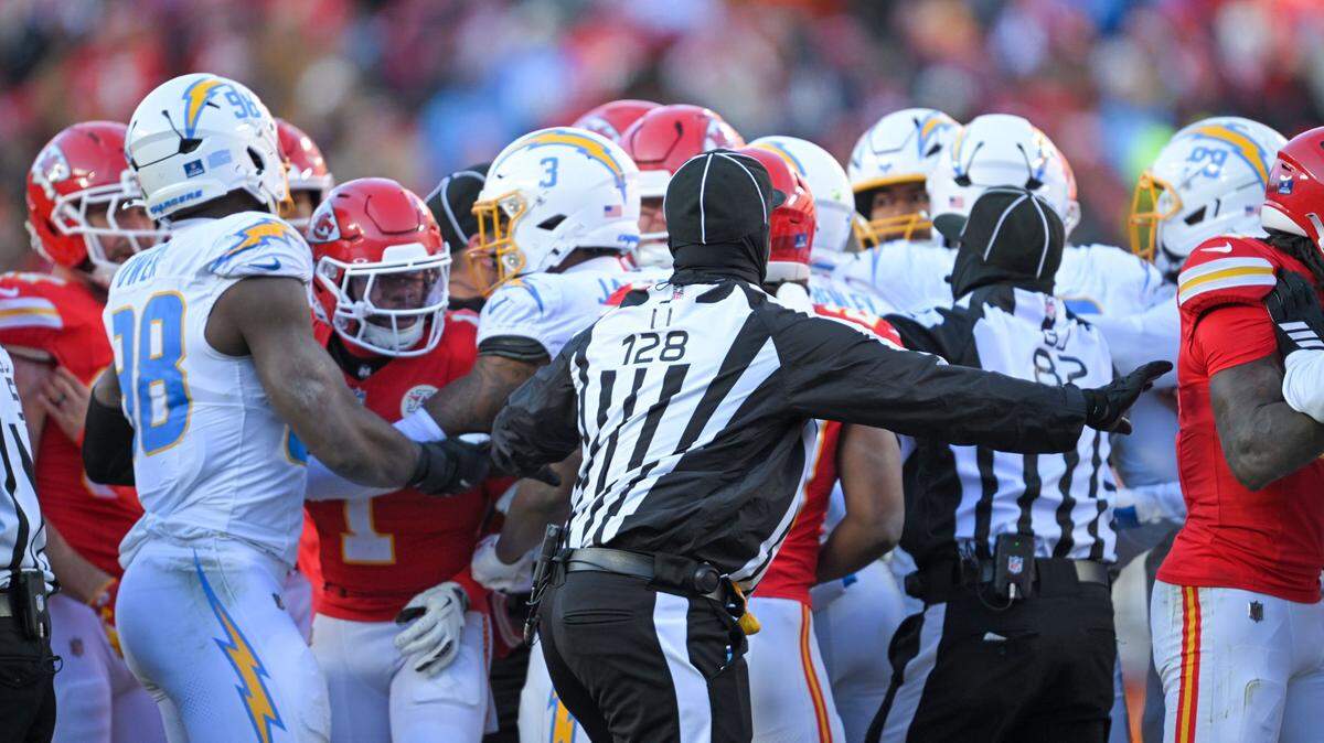 A skirmish breaks out between the Los Angeles Chargers and Kansas City Chiefs as Los Angeles Chargers safety Tony Jefferson (23) was ejected for a helmet-to-helmet hit in the second half at GEHA Field at Arrowhead Stadium on Sunday, Dec. 14, 2025.