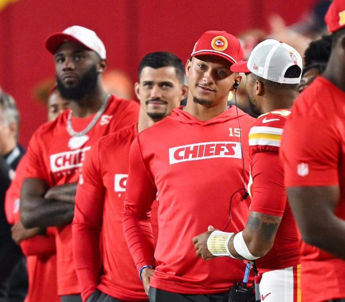 Kansas City Chiefs quarterback Patrick Mahomes, facing camera wearing cap, watches the final moments of a preseason game against the Chicago Bears at GEHA Field at Arrowhead Stadium.