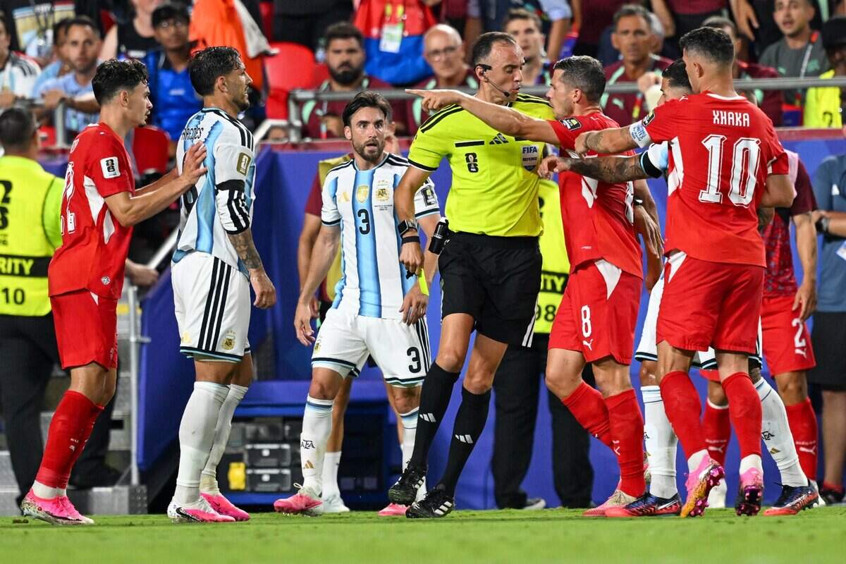 Switzerland midfielder Remo Freuler (8) has a heated exchange with the official following a VAR call that resulted in penalizing Switzerland forward Breel Embolo (7) with his second yellow card of the match resulting in a red card and removing him from the Argentina vs. Switzerland 2026 World Cup Quarterfinal football match at Kansas City (Arrowhead) Stadium in Kansas City on Saturday, July 11, 2026.