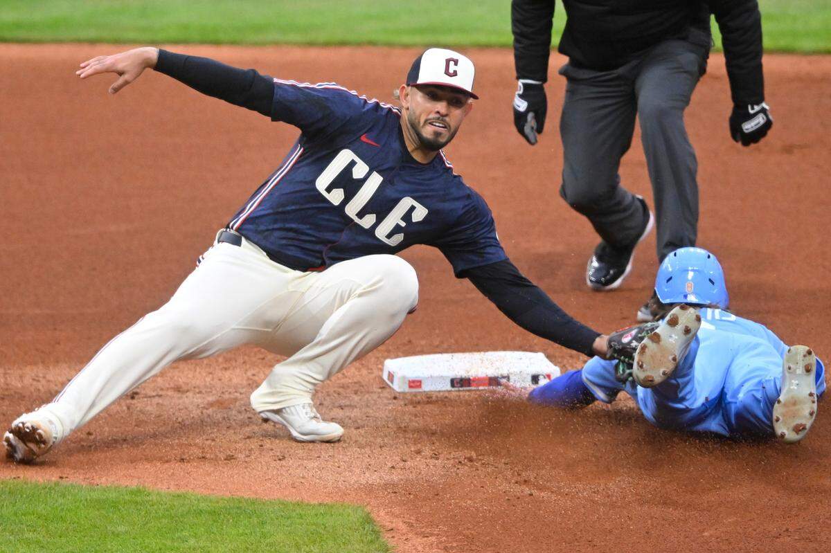 Kansas City Royals left fielder Drew Waters (8) is tagged out by Cleveland Guardians second baseman Gabriel Arias (13) while attempting to steal second base in the fourth inning at Progressive Field on Apr 11, 2025 in Cleveland, Ohio, USA.