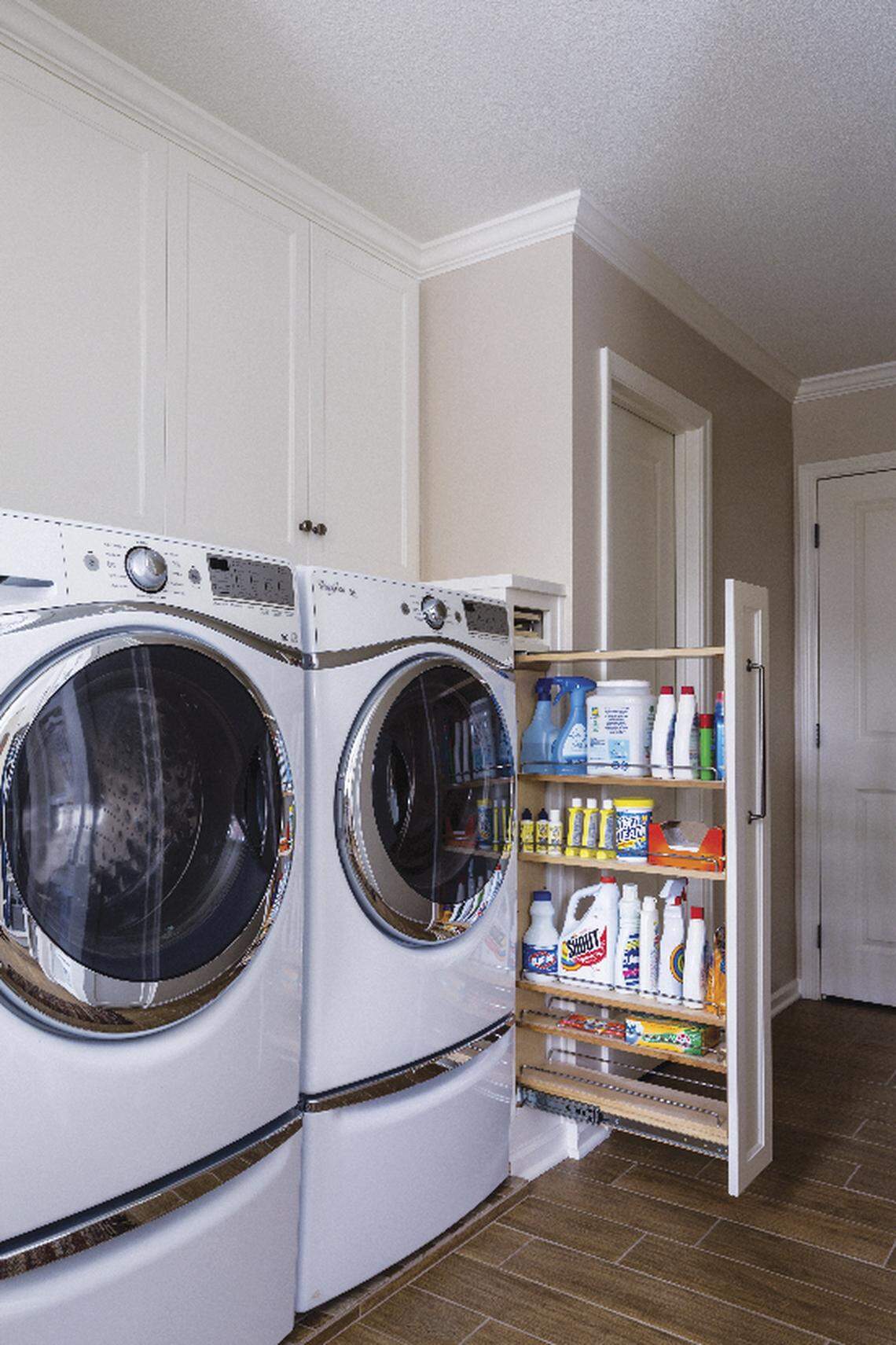 A custom-designed pull-out cabinet keeps laundry products close at hand and out of sight.